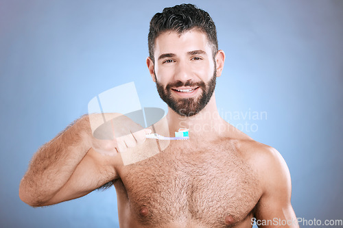 Image of Teeth, toothbrush and portrait of man in studio for dental wellness, healthy smile and mouth care. Happy face, male model and oral cleaning for fresh breath, gums and dentistry on blue background