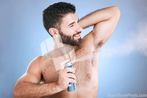 Image of Deodorant, spray and man in studio for hygiene, fresh scent or underarm perfume. Male model spraying armpit for body odor, smell and cleaning cosmetics, shower product and skincare mist on background