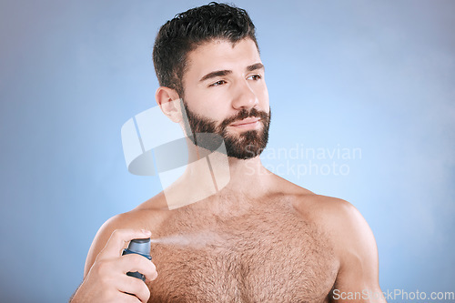 Image of Deodorant, body spray and man in studio for hygiene, fresh scent and sweating perfume. Male model spraying odor cosmetics, fragrance and cleaning skincare of beauty mist, shower product or background