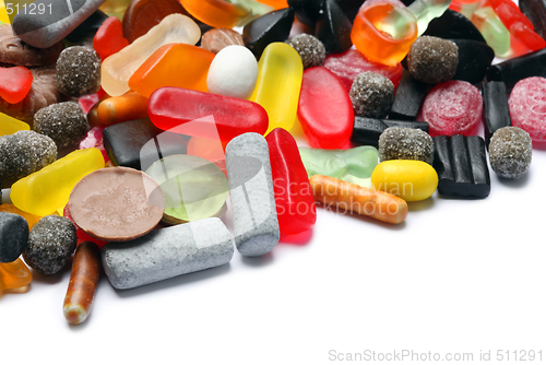 Image of Photo of colored candies over white background