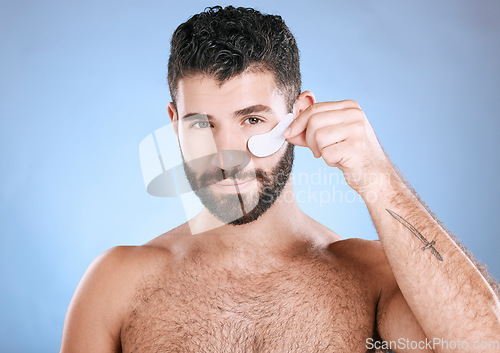 Image of Skincare, eyes patch and portrait of man, beauty and dermatology on studio background. Male model, face and eye care product for body mask, healthy cosmetics and wellness of facial collagen treatment