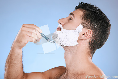 Image of Shaving chin, foam and man with razor, beard maintenance and product placement in studio mock up. Shave cream, face and hair or skincare for male model facial grooming, isolated on blue background.