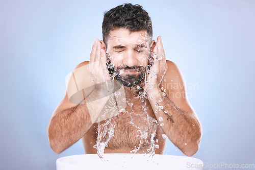 Image of Face, skin care and man with water splash for clean spa facial for beauty hygiene and dermatology. Aesthetic model person on blue background for health and wellness cosmetics, body and detox cleaning