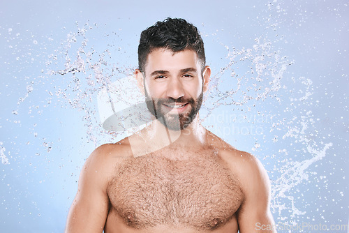 Image of Man, skin care and face portrait with water splash for clean facial beauty hygiene and dermatology. Happy model person on blue background for health and wellness cosmetics, body and detox cleaning