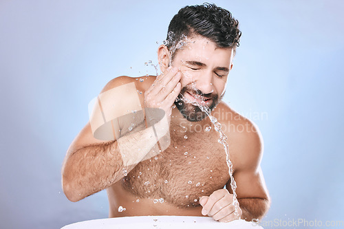 Image of Man, skin care and face with water splash for clean spa facial for beauty hygiene and dermatology. Aesthetic model person on blue background for health and wellness cosmetics, body and detox cleaning