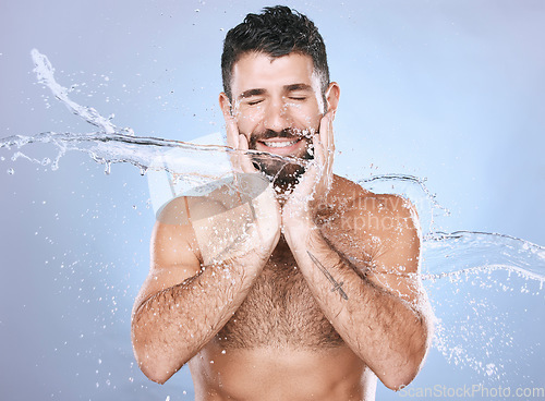 Image of Man, water splash and face skin care for clean spa facial for beauty, hygiene and dermatology. Aesthetic model person blue background for health and wellness cosmetics, body glow and detox cleaning