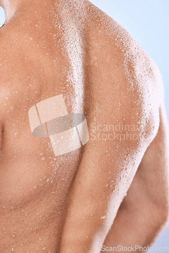 Image of Man, back and water drops for shower on background of skincare, hygiene and healthy dermatology. Closeup behind torso, strong male and wet human body with muscle, anatomy cleaning and studio wellness