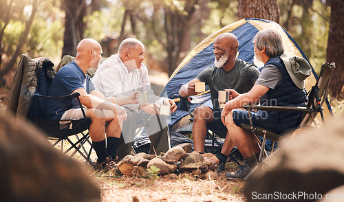 Image of Man, friends and camping in nature for holiday travel, getaway or summer vacation together by tent in forest. Group of elderly men relaxing on camp chairs with drink and enjoying day in the outdoors