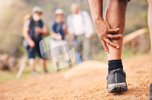 Image of Injury, leg pain and hands of senior black man after hiking or sports accident outdoors. Training hike, elderly and male with fibromyalgia, inflammation or arthritis, broken bones or painful muscles.