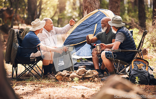 Image of Man, friends and camping in nature with coffee for travel, adventure or summer getaway together on chairs in forest. Group of men relaxing, talking or enjoying natural camp out by trees in outdoors