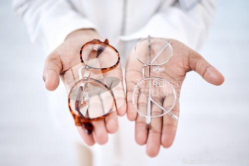 Image of Optometry, vision and hands with glasses for choice, option and choosing medical product for eyes. Optometrist, healthcare and palms with frame, prescription lens and eyeglasses for sight correction