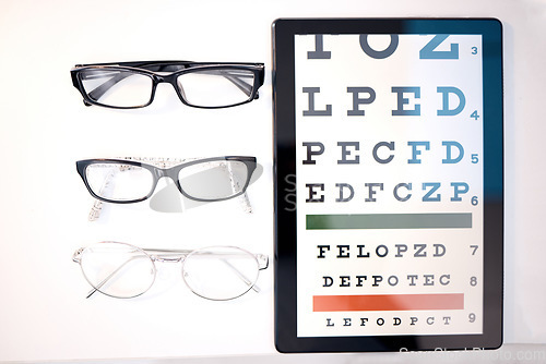 Image of Optometry, glasses and letter for eye exam on tablet for sight, vision testing and medical care. Optometrist, healthcare and frames, prescription lens and eyeglasses for eyes with test on screen