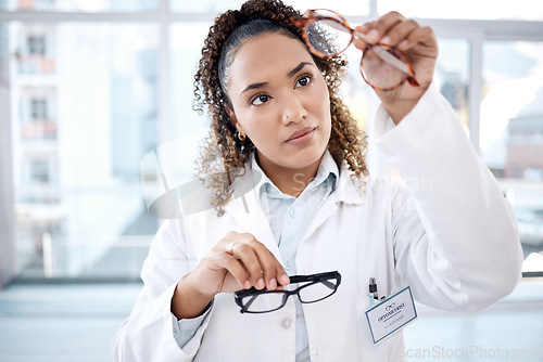 Image of Glasses, vision and black woman eye doctor check lens and frame for healthcare and optometry. Medical ophthalmology worker person in clinic or hospital for test, exam and care for eyes for wellness