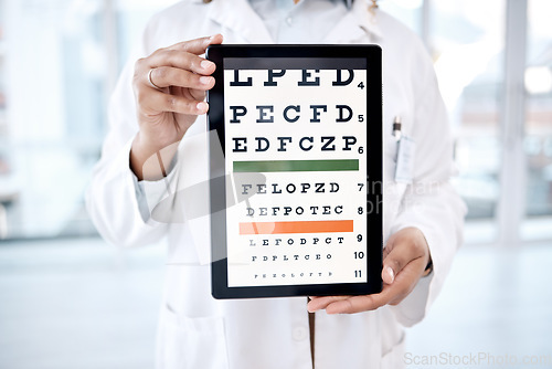 Image of Hands, tablet screen and optometry chart in hospital for vision examination in clinic. Healthcare, snellen or woman, ophthalmologist or medical doctor holding technology showing letters for eye test.