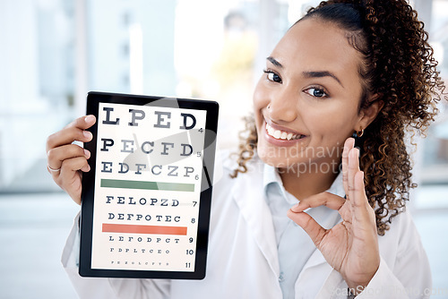 Image of Optometry chart, tablet and doctor with ok sign in hospital for vision examination in clinic. Healthcare, snellen touchscreen and optometrist or black woman with tech, hand gesture and eyes test text