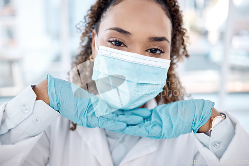 Image of Portrait, covid and cute with a black woman nurse in the hospital, wearing a mask for health and safety. Face, medical and healthcare with a female medicine professional posing closeup in a clinic