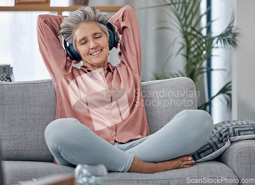 Image of Relax, music and headphones with old woman on sofa for peace, wellness and streaming. Mobile radio, podcast and technology with lady listening in living room at home for health, happy and zen mindset