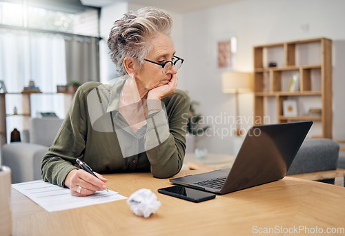 Image of Focus, planning and senior woman on laptop writing, work from home budget or financial strategy. Person thinking, reading debt and pension document or insurance paperwork, taxes or finance investment