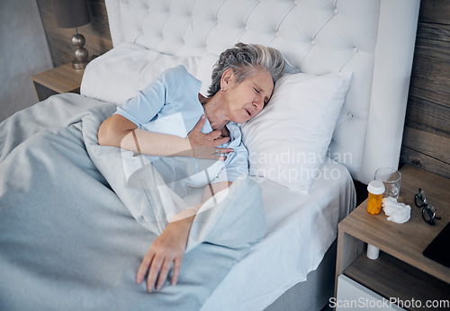 Image of Heart attack, bedroom and senior woman with chest pain, sick and medical risk with medicine. Pills, stress or stoke of elderly person cardiology, breathing or lung problem with healthcare emergency