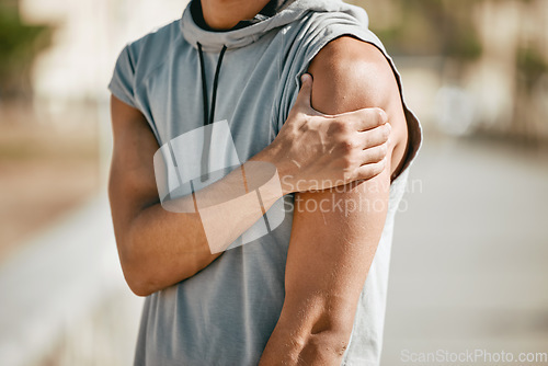 Image of Arm, mockup and man in street with injury or ache in fitness, sports or cardio on blurred background. Shoulder pain, runner and hands of guy suffering heart attack sign, accident or risk in workout