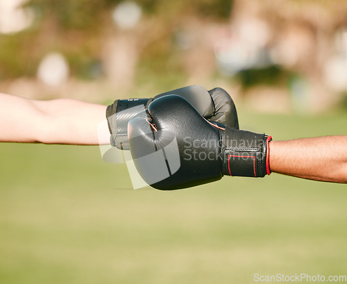 Image of Team, boxing gloves and people fist bump in celebration, collaboration and teamwork in combat sports outdoors. Boxer, hands and friends or fighter training together as workout, exercise and fitness