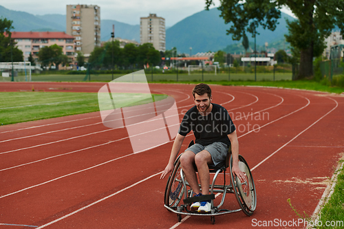 Image of A person with disability in a wheelchair training tirelessly on the track in preparation for the Paralympic Games