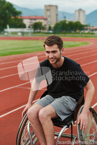 Image of A person with disability in a wheelchair training tirelessly on the track in preparation for the Paralympic Games