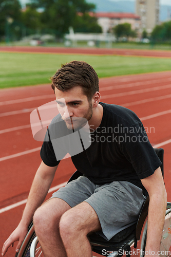 Image of A person with disability in a wheelchair training tirelessly on the track in preparation for the Paralympic Games