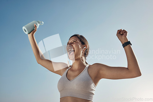 Image of Fitness winner, workout and woman with drinking bottle for achievement outdoor. Excited, smile and athlete with blue sky feeling freedom from motivation and happiness with exercise target goal