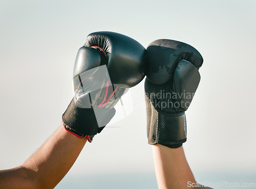 Image of Boxer, boxing gloves and friends fist bump in celebration, collaboration and teamwork in combat sports outdoors. Fighter, hands and people training together as workout, exercise and fitness