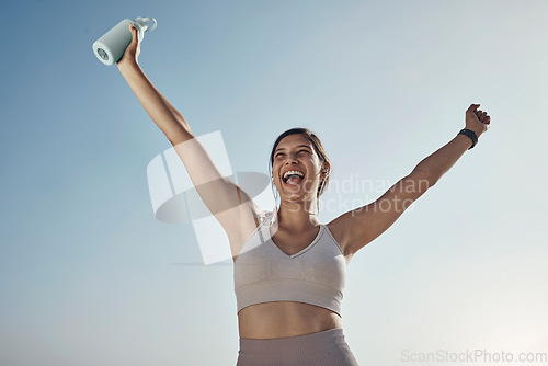 Image of Fitness success, blue sky and woman arms in air with water bottle outdoor. Excited, happy smile and athlete with sports feeling freedom from motivation and happiness with exercise target goal