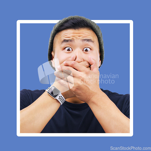 Image of Portrait, man and hands over mouth for wow, shocked and news in studio for advertising on blue background. Omg, face or emoji by asian guy shock for secret, drama or secret on mockup space isolated