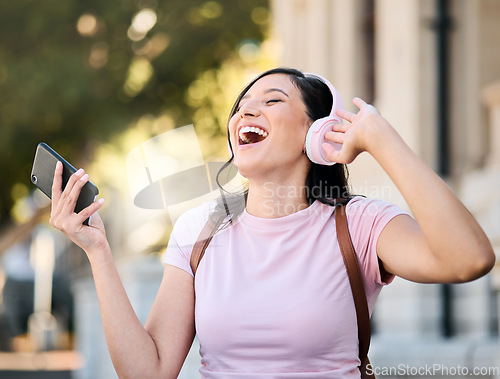 Image of Music, headphones or dance by woman in city for travel, happy and freedom on building background. Radio, podcast and travelling girl student smile for app, online audio or subscription service