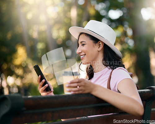 Image of Happy, search or woman with phone on park bench in morning for social media, networking or reading comic blog. Smile, coffee or girl on 5g smartphone for freedom, web or internet news communication