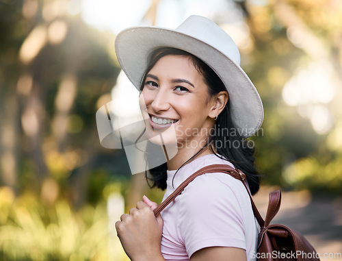 Image of Woman smile, portrait and park walk of a young person happy about nature, travel and freedom. Happiness, backpack and laughing female with blurred background in a garden feeling relax and summer fun