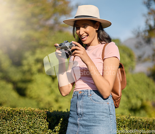 Image of Photography, tourism and woman with a camera in nature for travel memory in Sweden. Summer, tourist and photographer looking at photos while traveling on a vacation in a park or botanical garden