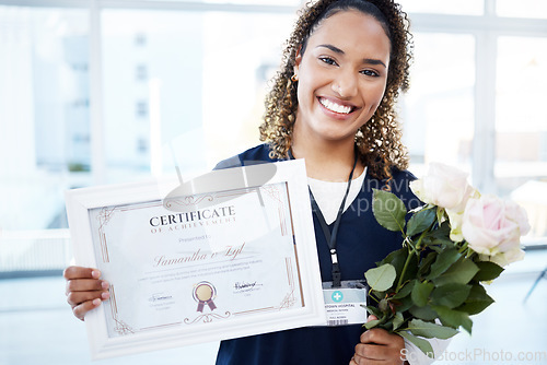 Image of Certificate, flowers and portrait with a black woman graduate in the hospital, proud of her achievement. Smile, graduation and qualification with a happy young female nurse standing alone in a clinic