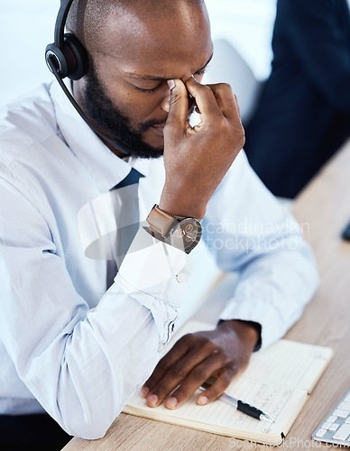 Image of Sad, anxiety and headache by consultant worker, customer service and call center employee in office. Pain, mental health and depressed telemarketing agent overworked and frustrated at the workplace