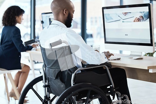 Image of Wheelchair, office and black man disability in the workplace doing business analyst work. Working, computer and desk job of a disabled worker back planning a digital strategy for inclusive job