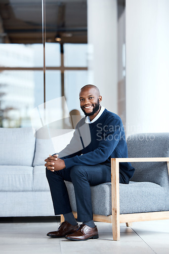 Image of Man, happy and therapist waiting in chair at workplace for consultation or interview in an office building smiling. Portrait, employee and African American worker with positive mindset and excited