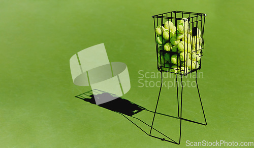 Image of Tennis, sport ball basket of sports field on a green training court outdoor with no people. Exercise, fitness and workout equipment shadow for match of game competition on turf ground with mockup