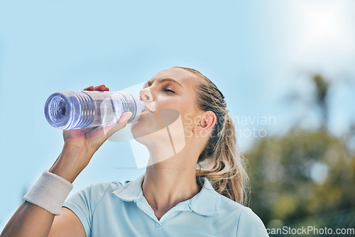 Image of Woman, tennis player and drinking water for hydration after workout, exercise or intense training in nature. Sporty female with bottle for refreshing drink to stay hydrated during sports exercising