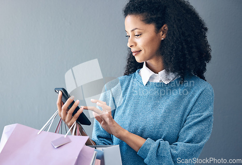 Image of Shopping bag, phone or black woman for fashion sale, discount or luxury brand store. Mockup, internet or girl with smile on smartphone for social media, promo code or online retail website app news