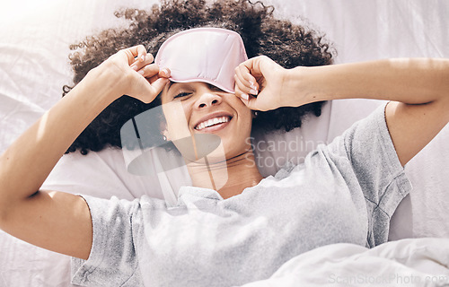 Image of Sleeping, wake up and black woman with eye mask in bed, dream and refresh body and mind in apartment or hotel. Dreaming, rest and relaxation, smile and beauty sleep late on weekend morning in bedroom