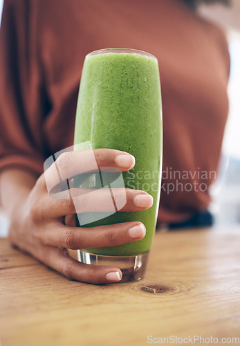 Image of Hand, glass and smoothie with a black woman holding a health beverage for a weight loss diet or nutrition. Wellness, detox or drink with a healthy female enjoying a fresh fruit and mint juice