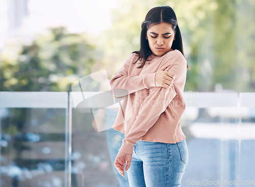 Image of Arm, pain and mockup with an indian woman holding her shoulder on a glass background while suffering from cramp. Medical, anatomy or muscle and a person struggling with an injury from an accident