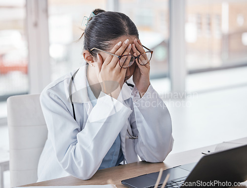 Image of Burnout, stress or doctor woman on laptop with headache from depression, mental health or anxiety medical review. Tired, pain or sad nurse frustrated, angry or depressed for medicine report in office