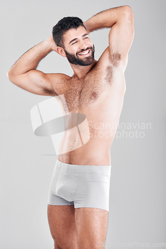 Image of Body, underwear and strong man in studio for exercise, fitness and wellness on a grey background. Happy aesthetic model for health, lose weight motivation and stomach or sexy muscle on healthy diet