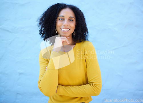 Image of Portrait, proud and black woman in studio on mockup, space and blue background for advertising. Face, smile and girl relax on backdrop, cheerful and confident, cool and posing inside on copy space