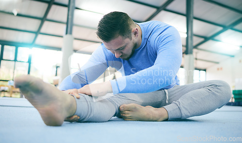 Image of Man, gymnastics or stretching legs on training floor, studio arena or fitness practice for competition flexibility or dynamic art. Rhythmic gymnast, athlete or warm up exercise in dance sports health